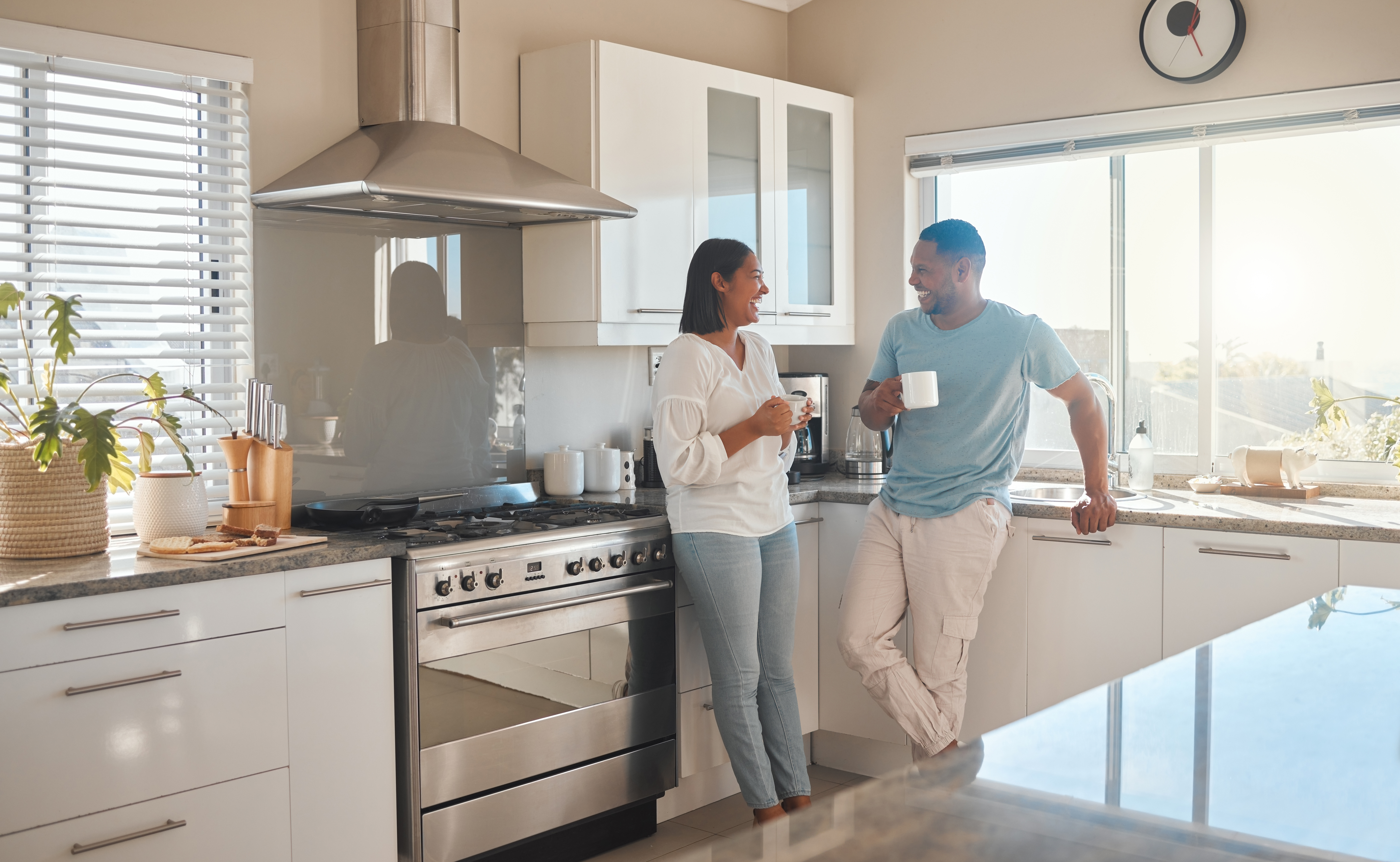 Couple standing in their kitchen discussing using their HELOC for home renovations