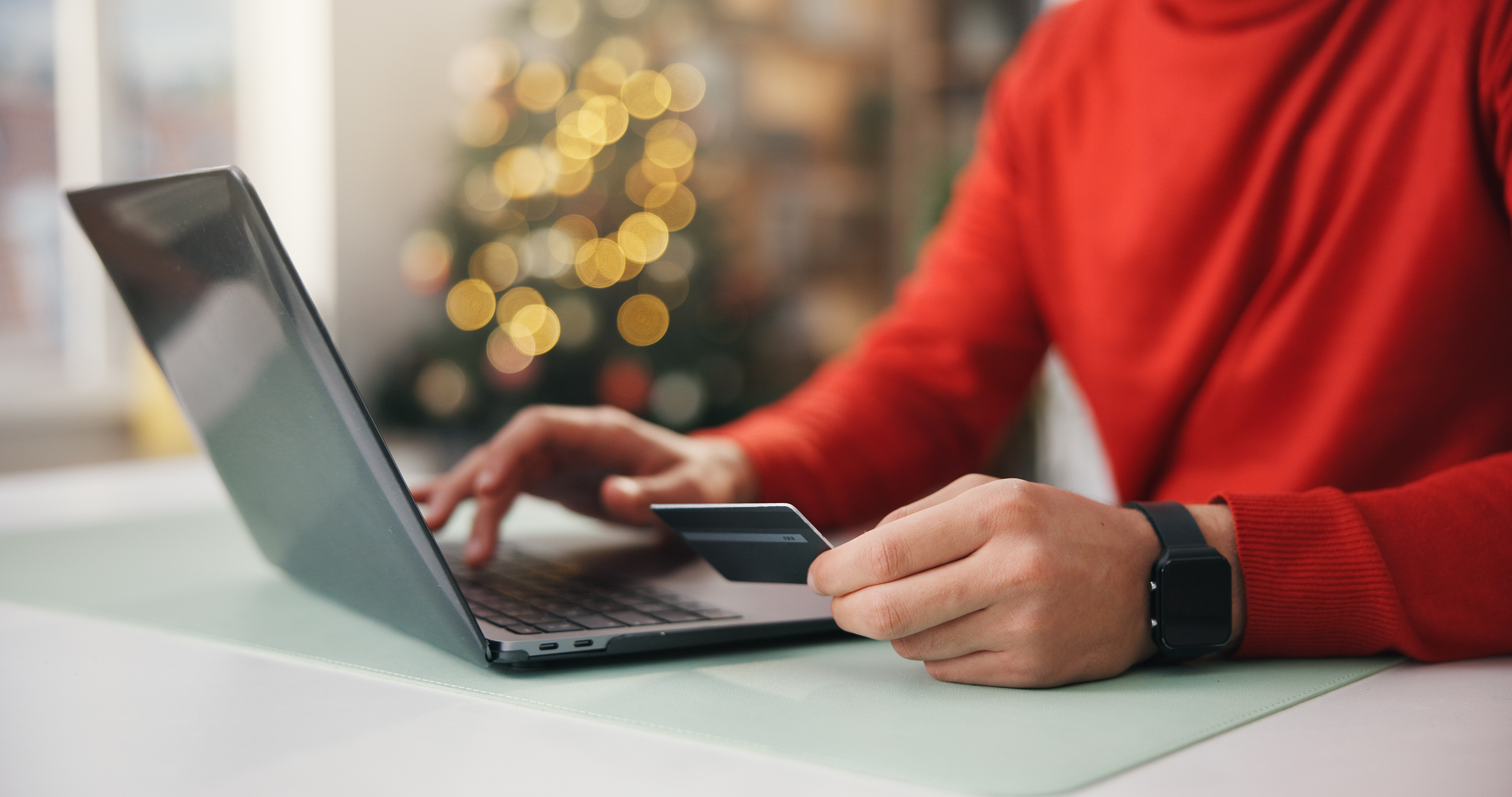 Woman online shopping with credit card and laptop